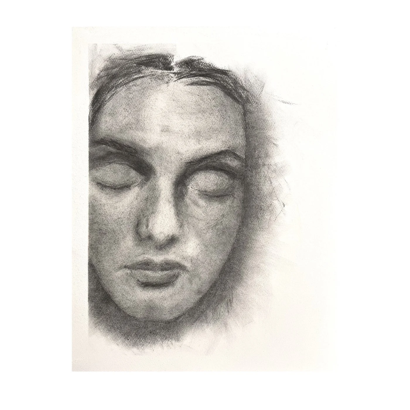 Charcoal portrait drawing of a face with closed eyes emerging from soft grey tones on a white background.