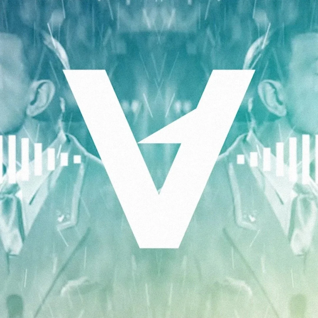 A digitally edited photo of a person wearing sunglasses and a jacket, with a large white letter 'V' and a triangle shape overlapping in the center, creating a mirrored or symmetrical effect.