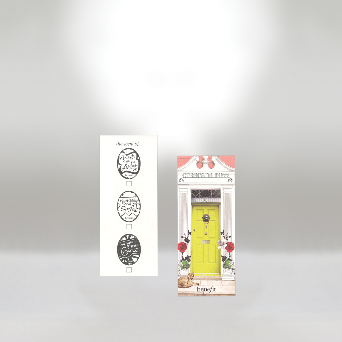 Benefit brand bookmark with a yellow door illustration, floral details, and the word 'benefit' at the bottom, alongside a white strip with three black-and-white circle designs containing text.