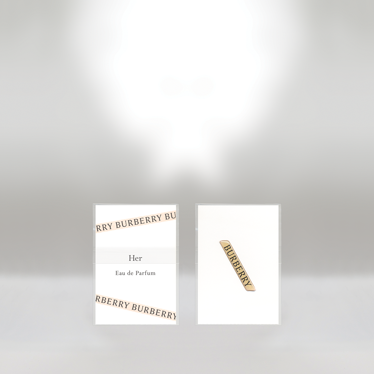 Two perfume packaging boxes with Burberry branding, one labeled 'Her Eau de Parfum' and the other with a Burberry logo.