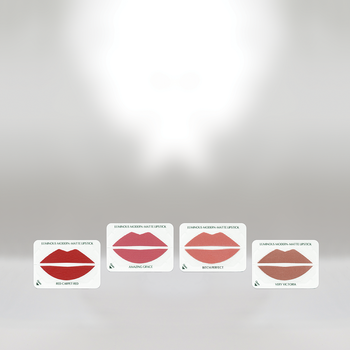 Four cards displaying different shades of matte lipstick, labeled from left to right: 'Red Carpet Red,' 'Amazing Grace,' 'Bitch Perfect,' and 'Very Victoria.'