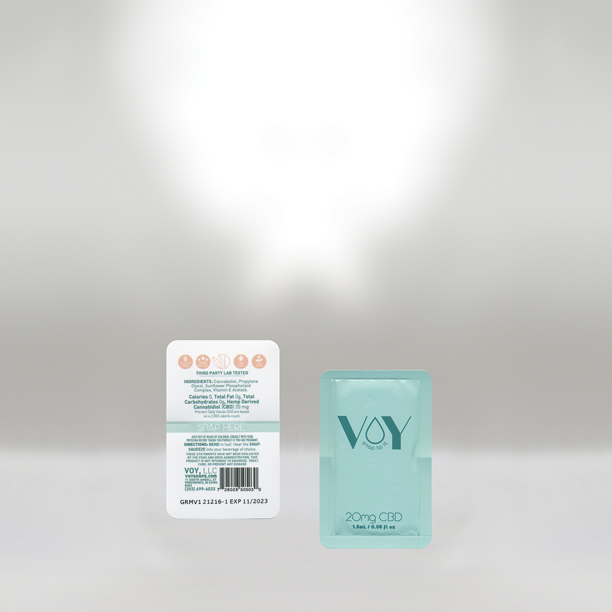 A pack of CBD products, including a white card with ingredients and instructions and a teal box labeled 'VOY SNAP TO IT 20mg CBD 1.5ml'.