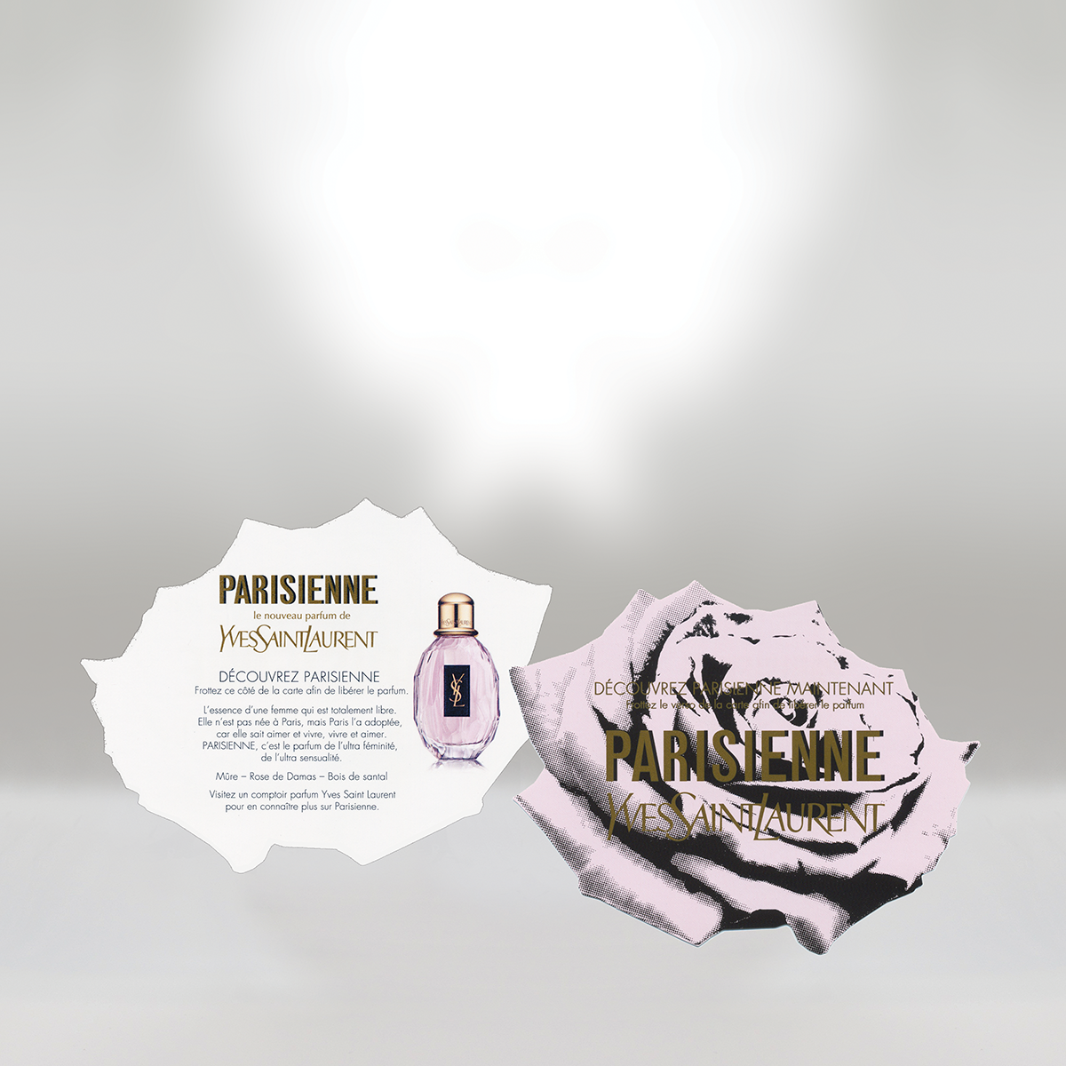 Yves Saint Laurent Parisienne perfume advertisement with pink perfume bottle and rose graphic.