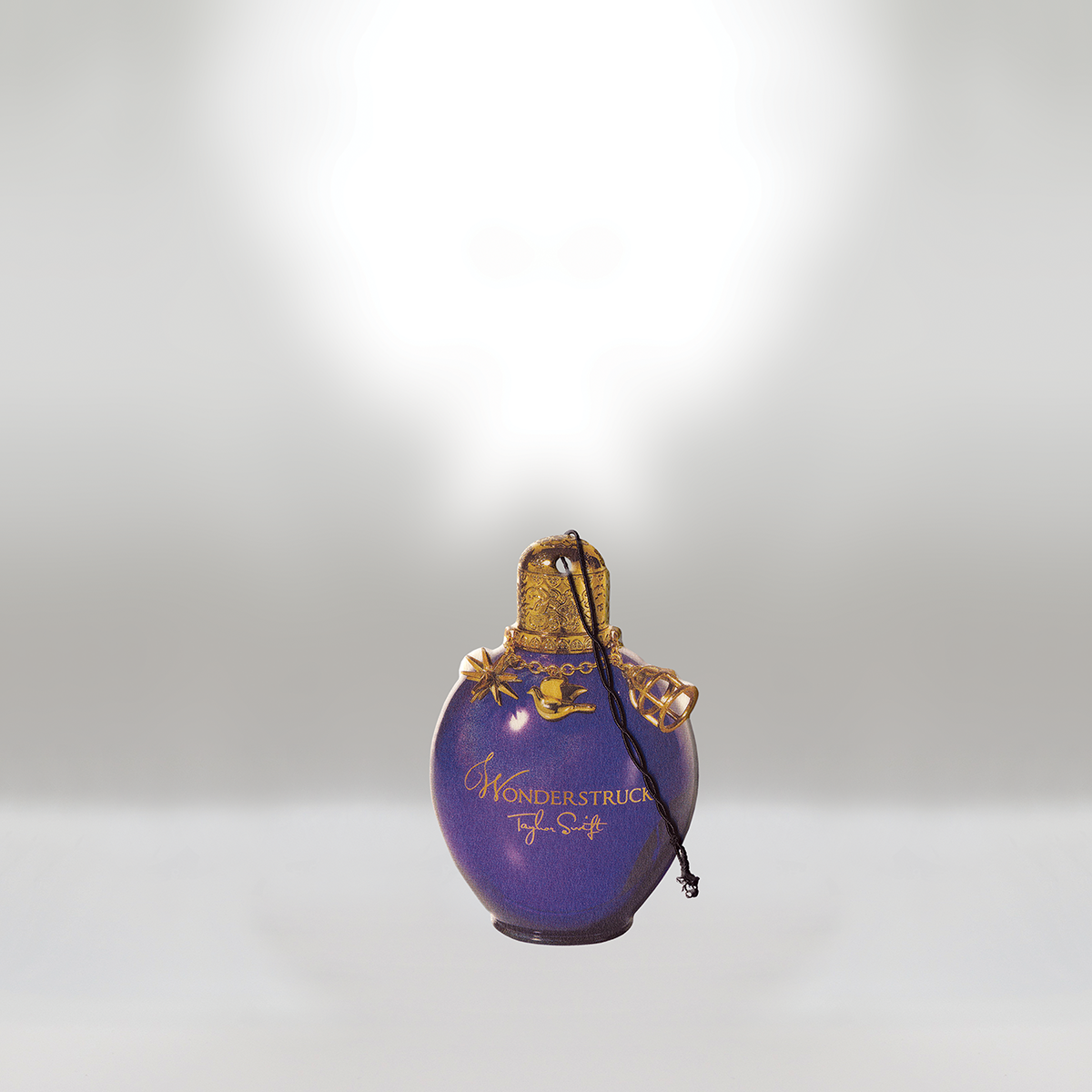 A purple perfume bottle with gold accents and a decorative cap, labeled 'WONDERSTRUCK Taylor Swift', set against a light gray background.