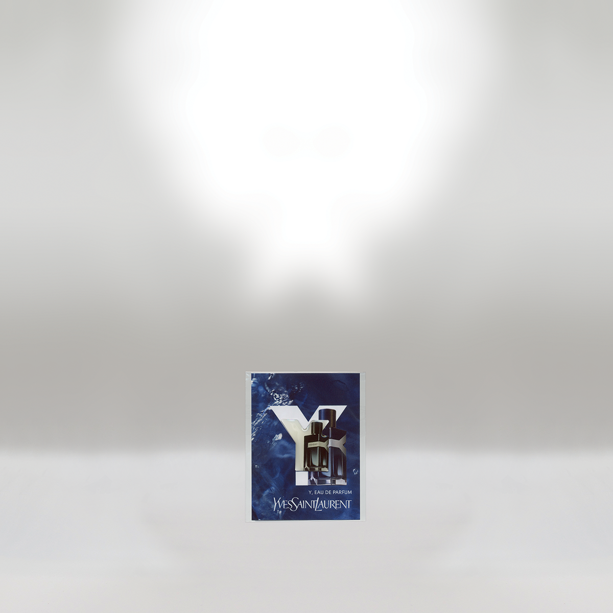 Yves Saint Laurent Y Eau de Parfum sample with a blue abstract background and a black perfume bottle.