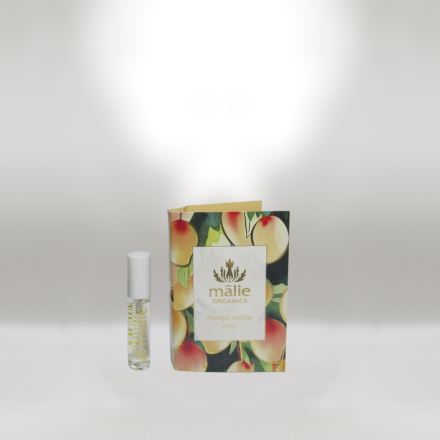 A small tube of Malie Organics mango nectar mist next to its floral-themed packaging box against a plain white background.