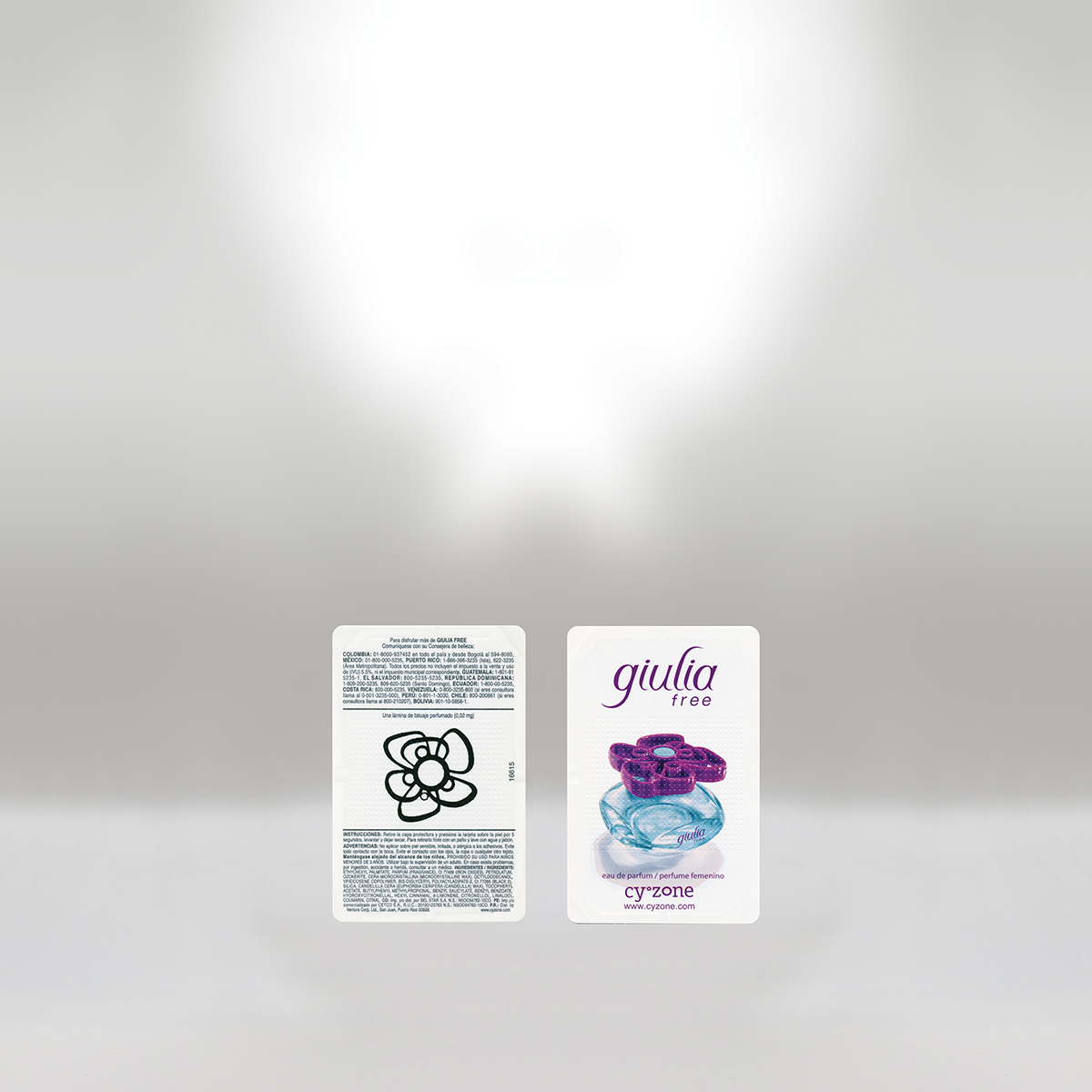 Back side of a perfume sample card and front side of a perfume box for Giulia Free fragrance on a plain white background.