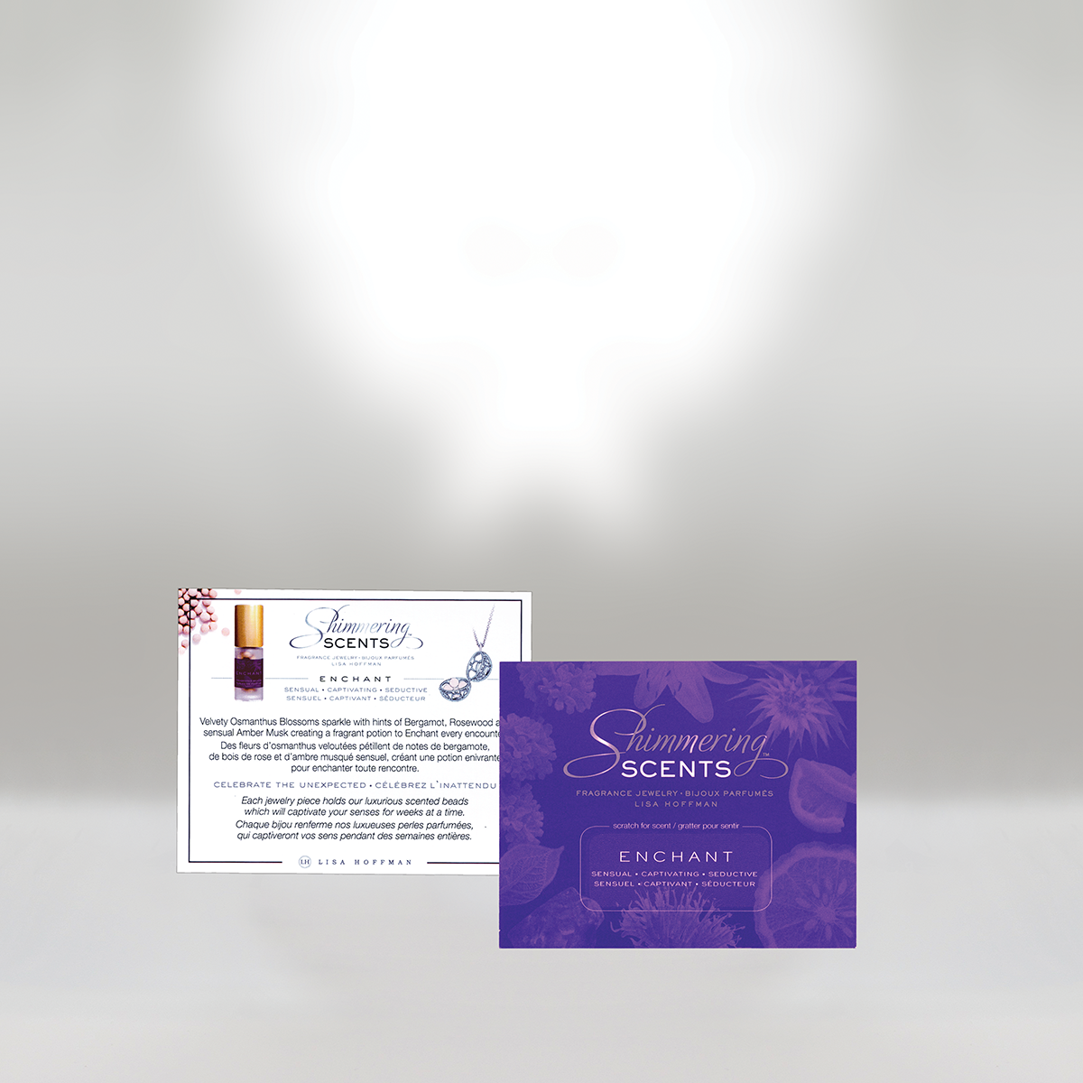 Two scent product cards, one purple and one white, with floral and perfume bottle graphics, promoting shimmering scents and enchant fragranced jewelry.