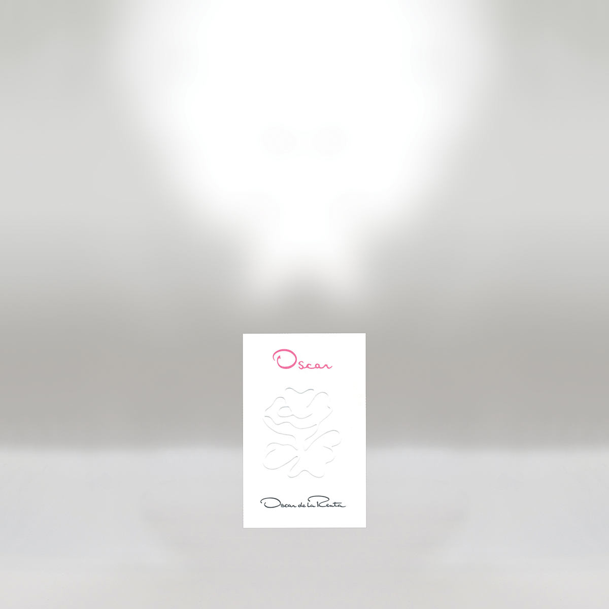 A white card with pink and black text and line art of a face, with the words 'Oscar' and 'Oscar de la Renta'.