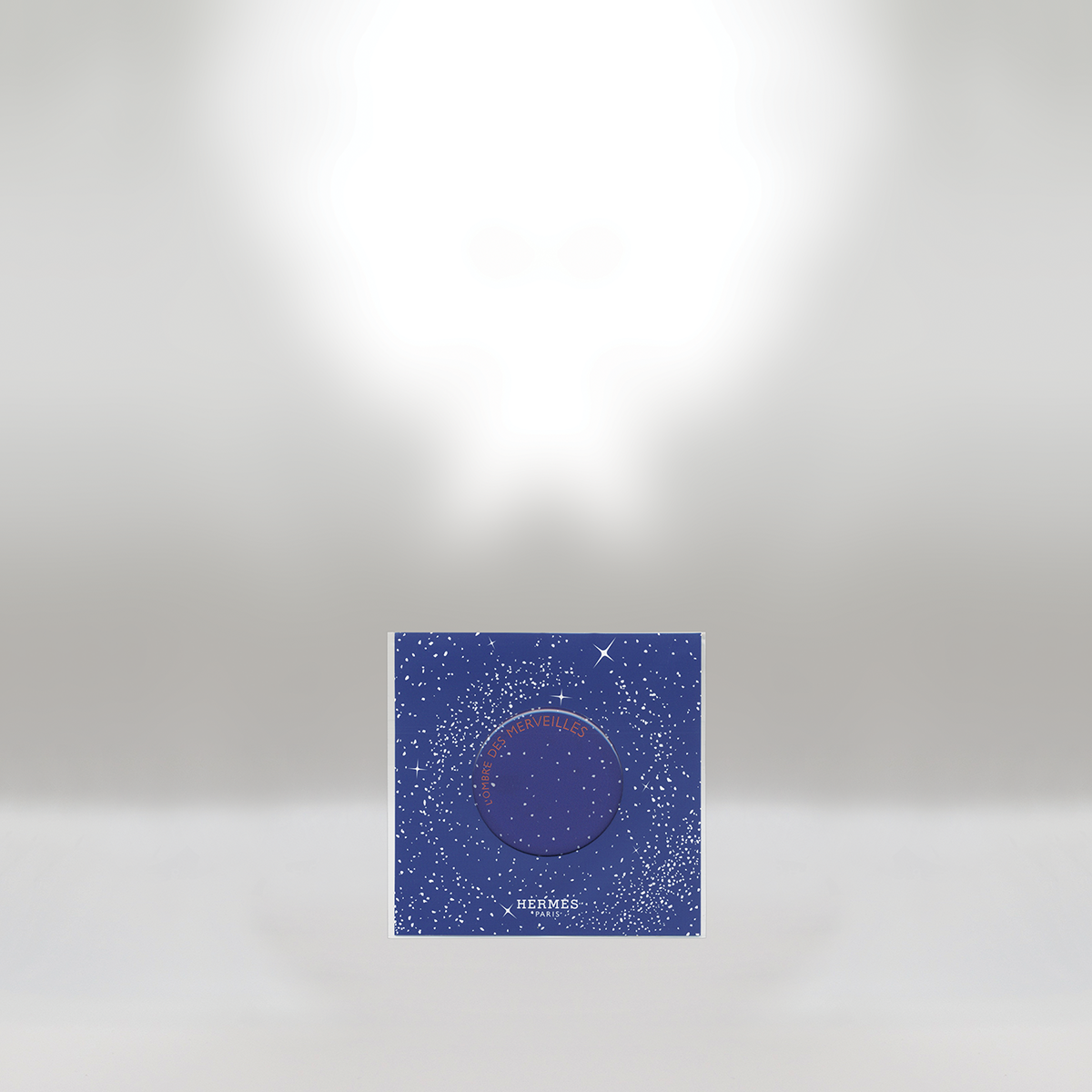 Hermès perfume box with a starry night sky design, predominantly blue with white stars, on a white background.