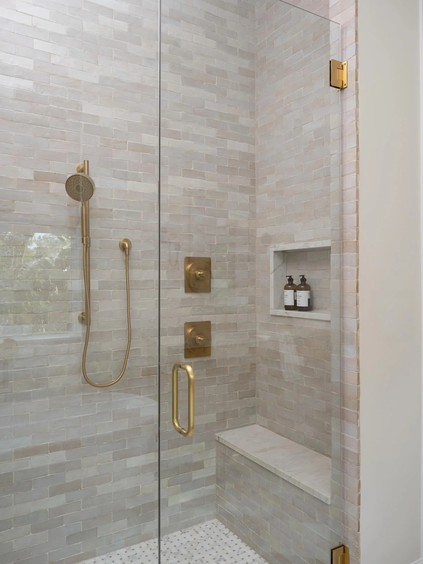 A primary bathroom shower full of zellige tile, natural stone and brass fixtures - the thoughtful details that matter most 🚿

📷: @frazier.springfield 

#danielleflaxinteriors #marylandinteriordesign #marylandinteriordesigner #annapolisinteriordesig