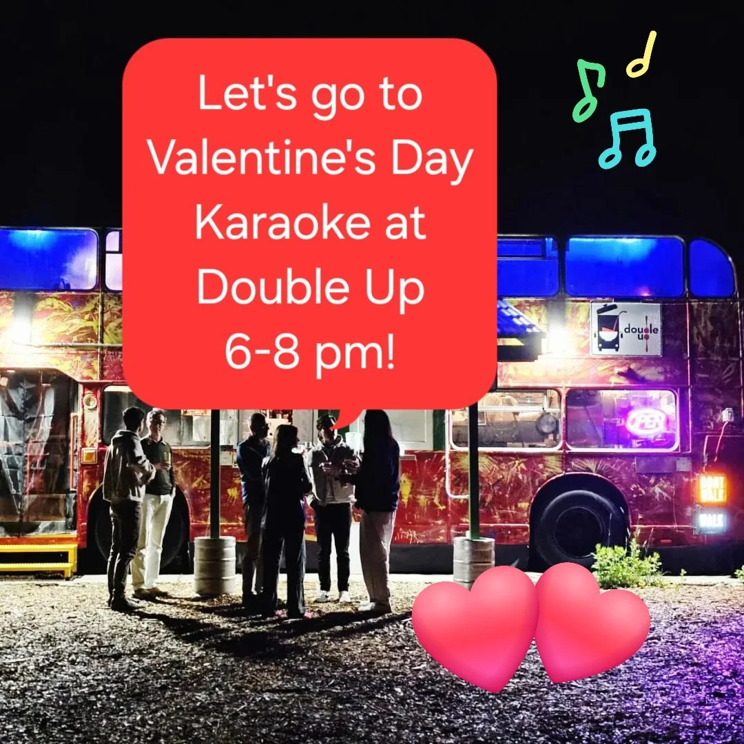 Group of people standing outside at night near a brightly lit double decker bus, with a speech bubble promoting Valentine's Day karaoke event at Double Up from 6 to 8 pm, surrounded by musical note icons and two pink hearts.