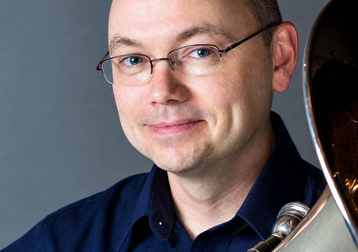 Smiling Musician with Brass Instrument.png