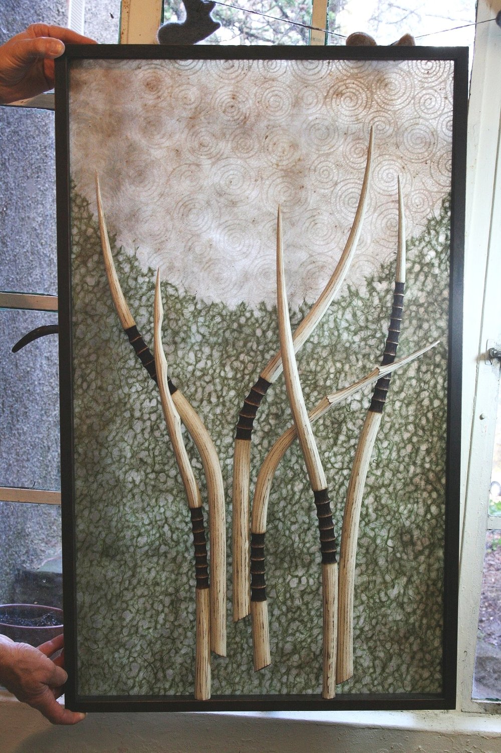  Commission Mel made for a client in Greensboro who collected some of her earliest pieces. Designed to cover a door window. Made from sculpted/painted/burned wood, mica, paper.  Very pagan, forest feel to this piece. 