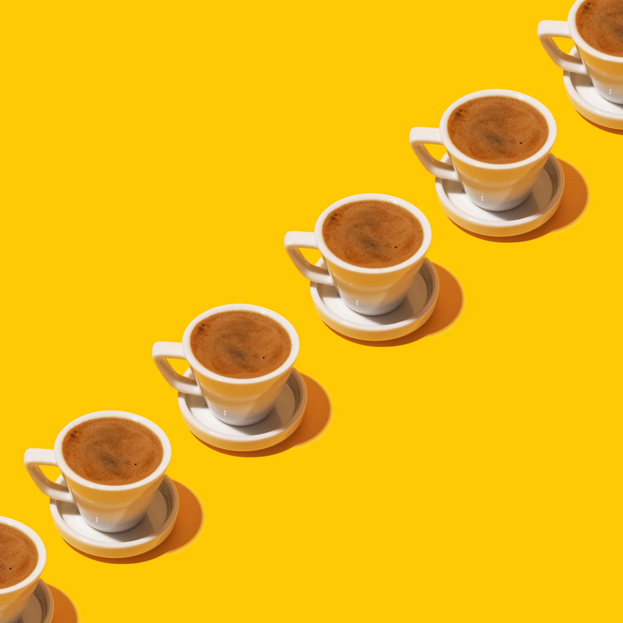 pattern of turkish coffee cups repeating on a yellow background