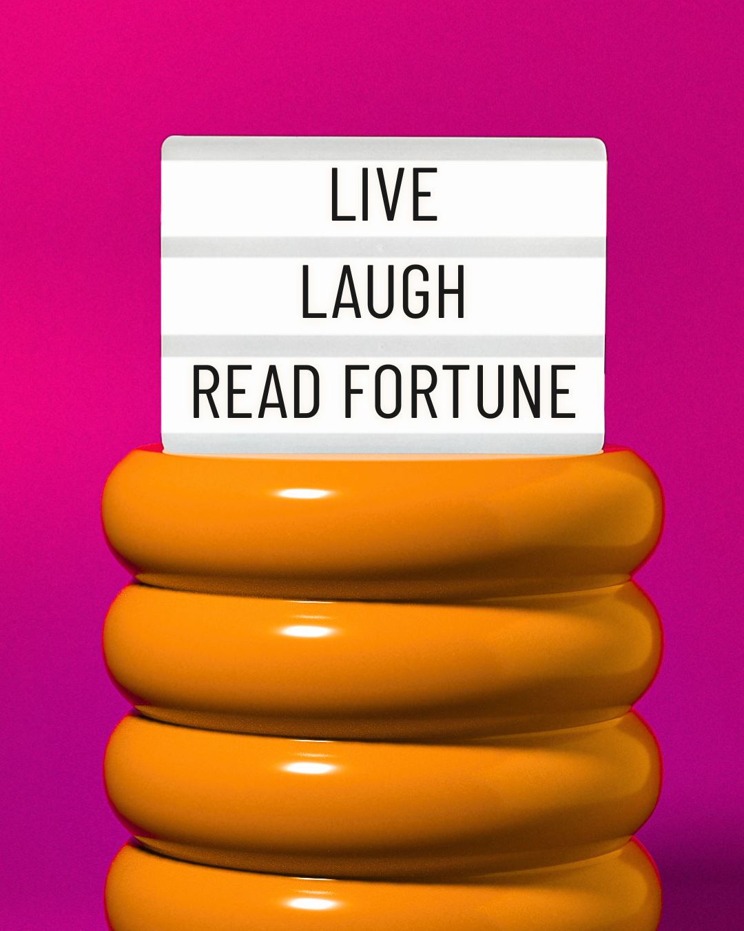 an image of an orange modern stool with a letter sign on it that says "live, laugh, read fortune"