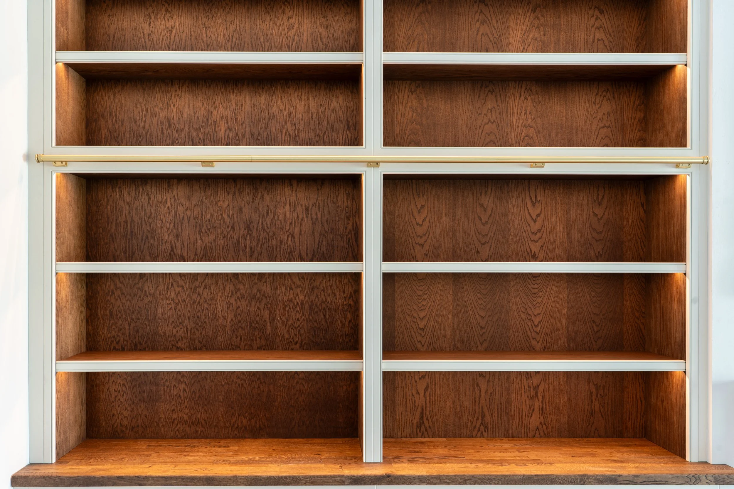 Empty wooden bookshelf with metal frame and built-in lighting