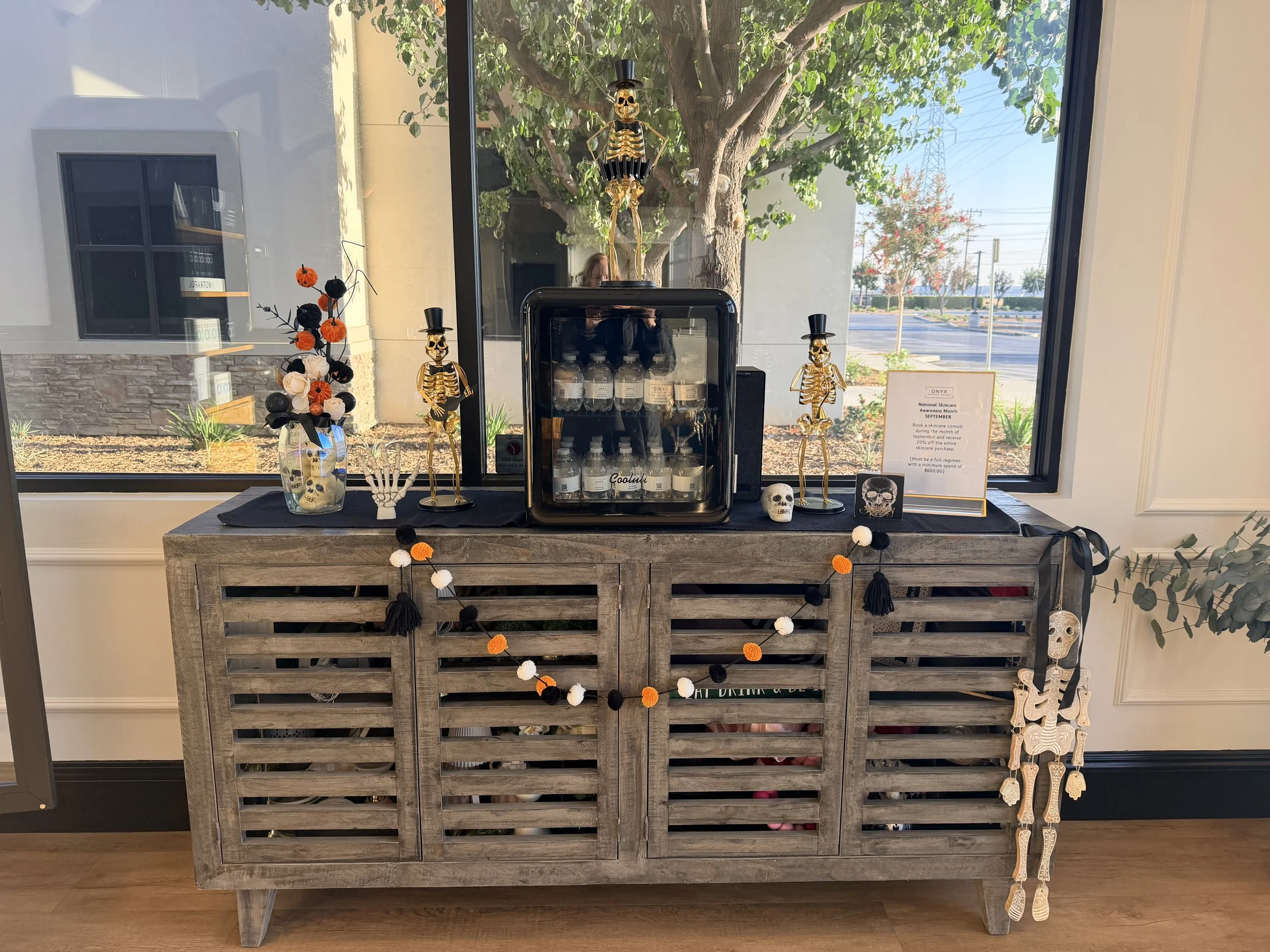 Beverage fridge on a rustic sideboard in the ONYX clinic