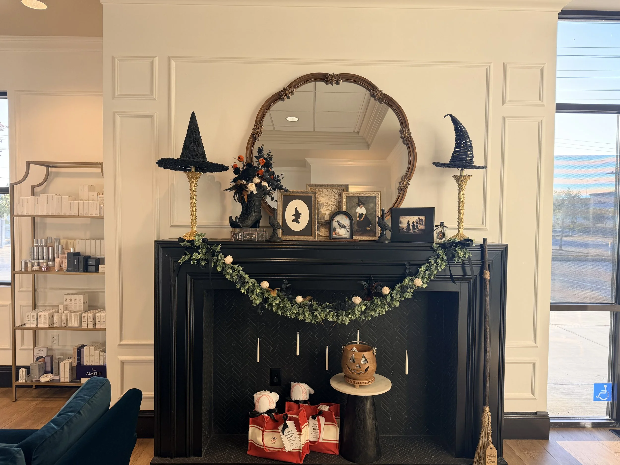 ONYX clinic lobby with a black fireplace, round mirror and skincare shelves