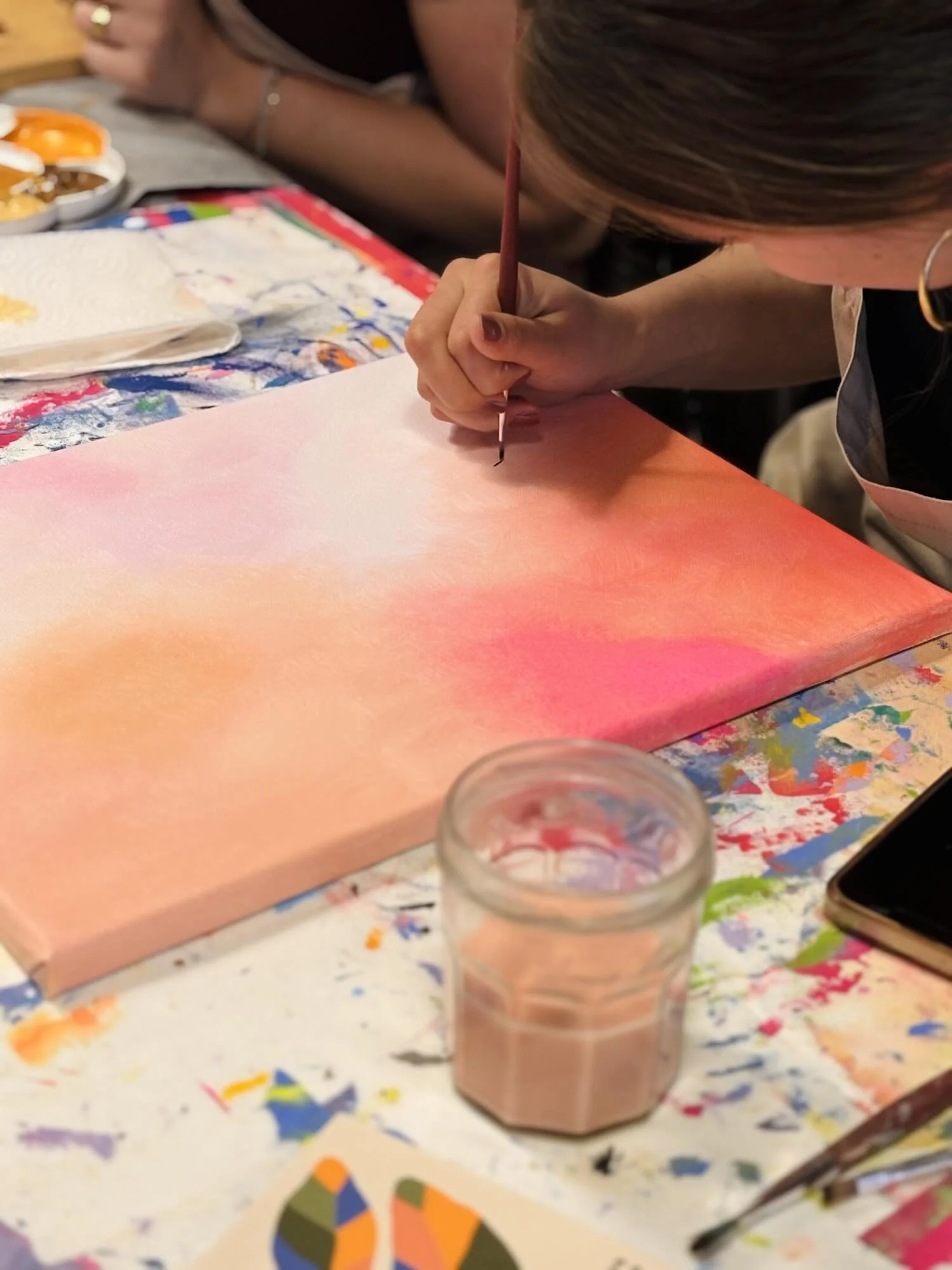Acrylgemälde pinker Pflanzen in einer blauen Vase mit rosaner Wand und gelbem Untergrund, auf weißem Stoffuntergrund