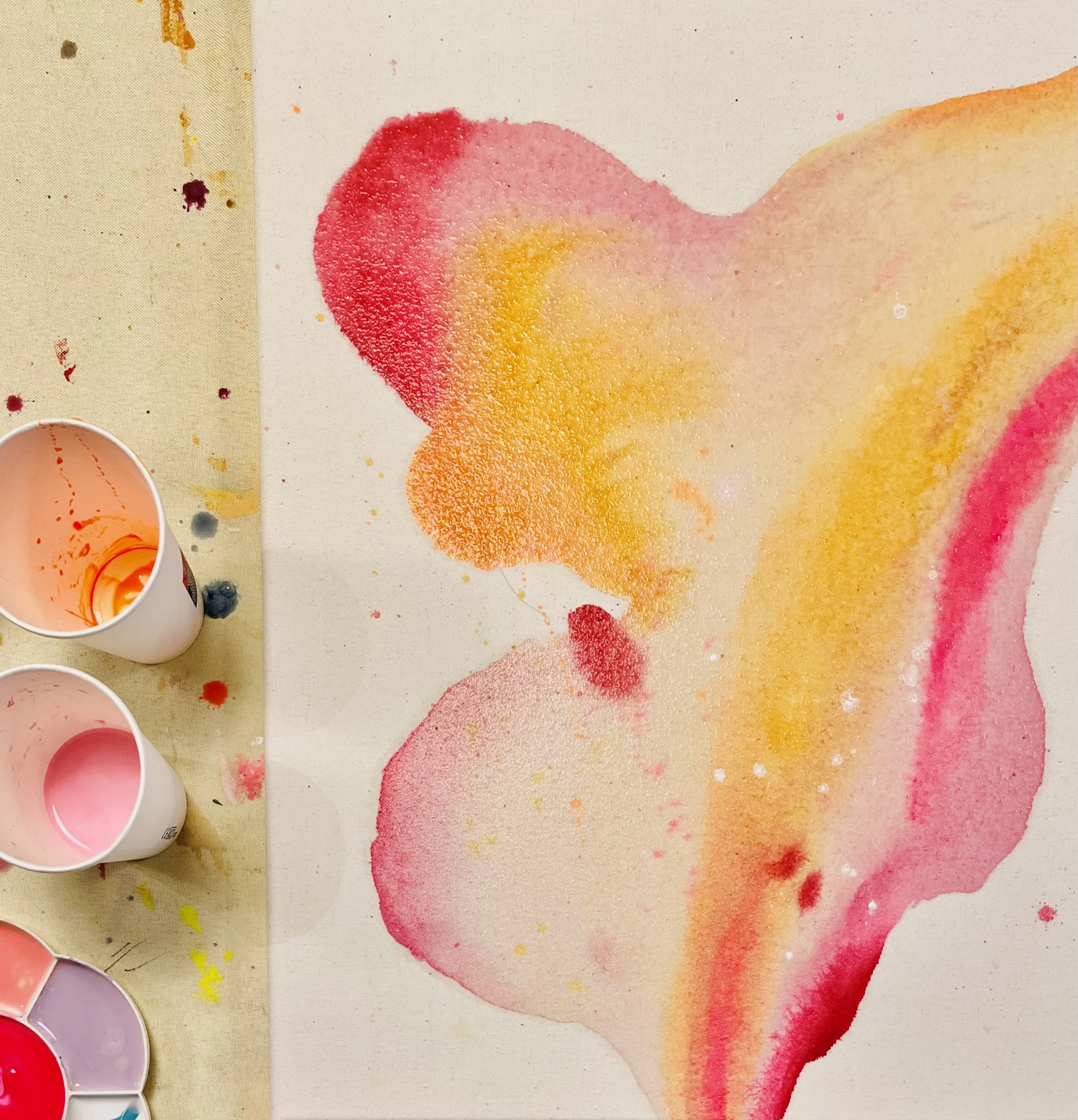 Ein abstraktes Kunstwerk mit bunten Farbklecksen in rosa und gelb