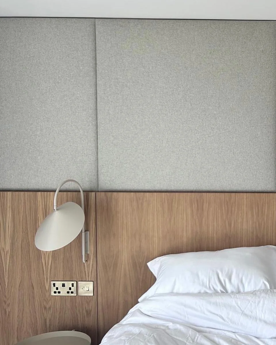 Soft fabric wall panels complete this seaside bedroom- adding warmth, texture, and sound dampening. Paired with bespoke oak veneer joinery by @coastal__carpentry and upholstered in @warwickfabricsuk Amatheon Porcelain fabric by @nativecreationsltd . 