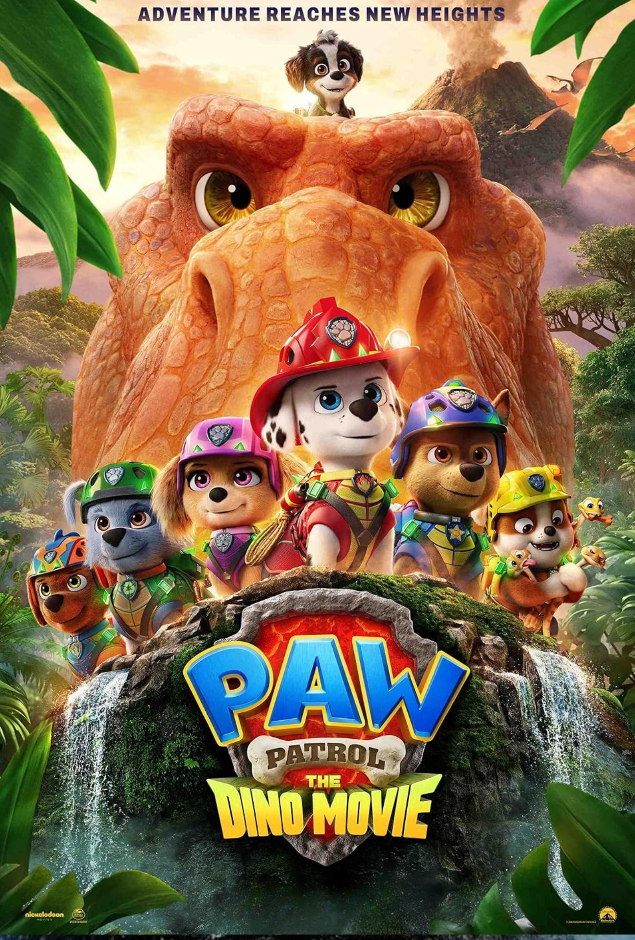 Poster for the movie 'Paw Patrol: The Dino Movie' featuring animated characters including dogs and a puppy dressed as firefighters, with a large dinosaur face and a volcano in the background, surrounded by jungle foliage and a waterfall.