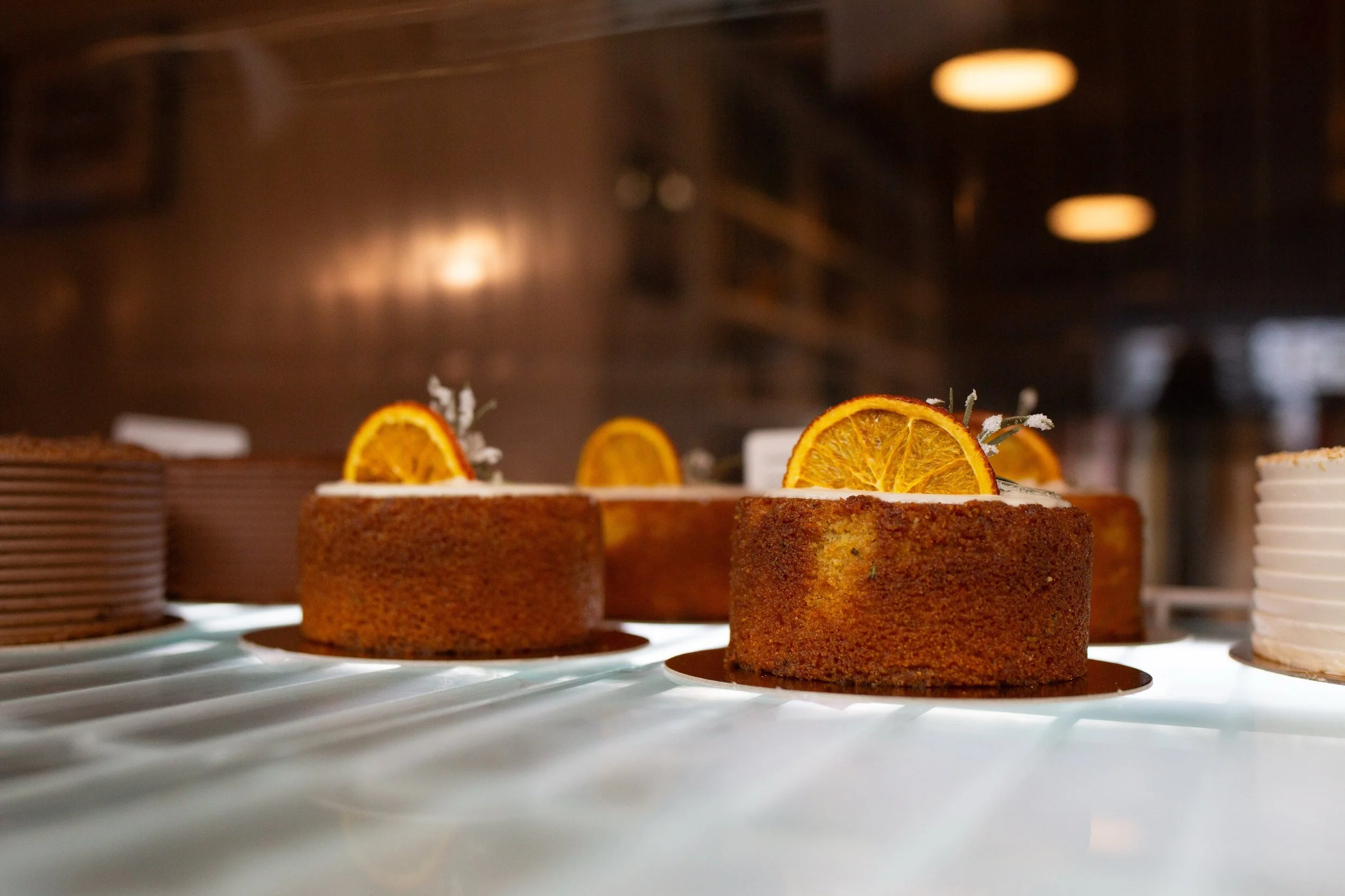 The cold case at our Airport Heights location was looking beautiful this morning! Stocked up with Orange rosemary polenta cake (gf), chocolate cupcakes, tropical cake, bakers choice cupcakes, and making their fall debut: &Eacute;clairs!! 

We hope yo