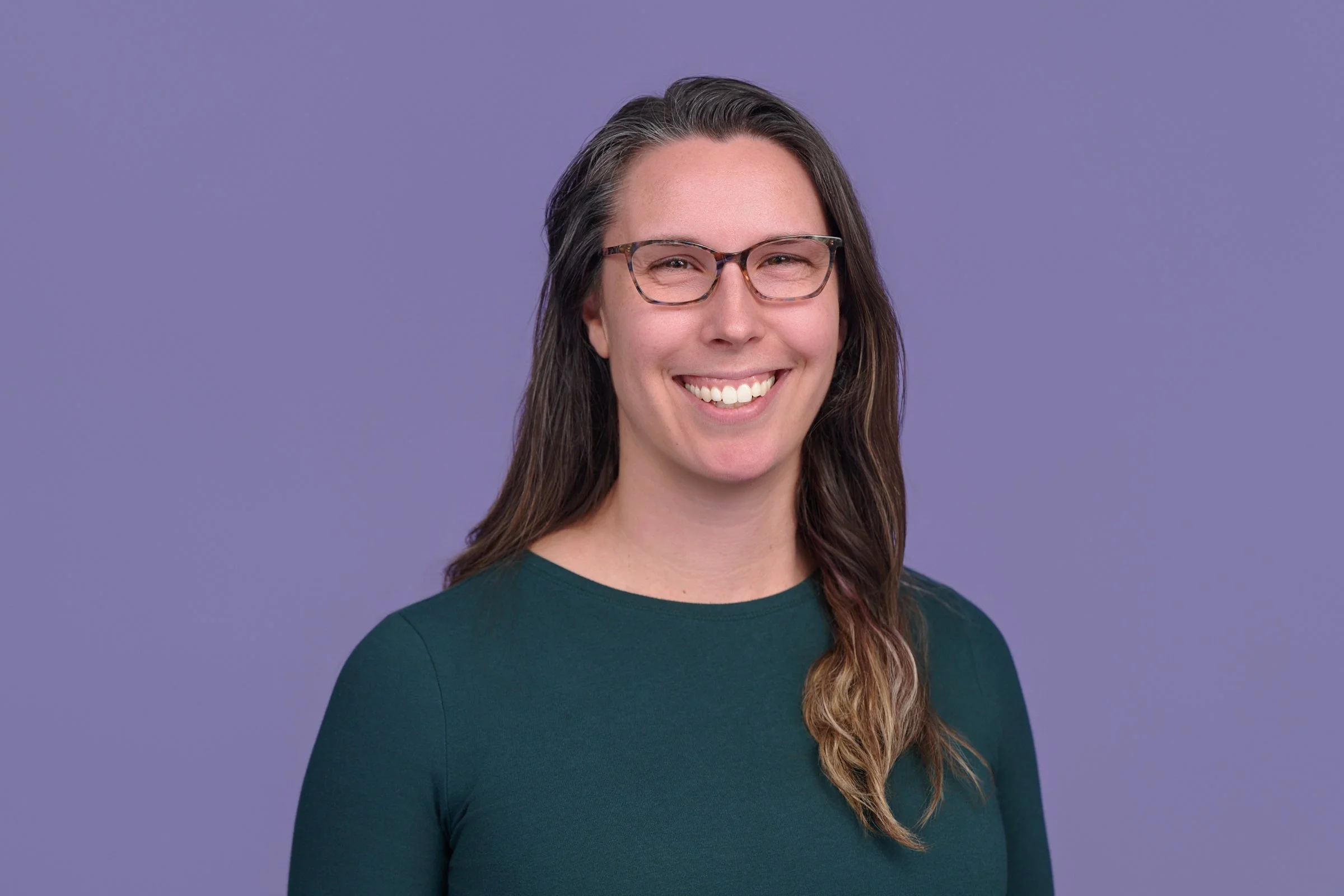 A stylized bar chart with three ascending bars in green, dark green, and blue, with black borders.