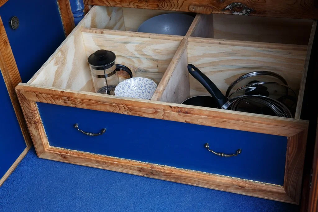 Under-bed storage drawers inside Azure, offering generous, well-organised space for cookware, food supplies and travel essentials. Designed for longer trips, this practical storage makes Azure an ideal campervan and motorhome hire option from Bristol