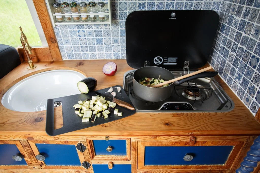 Fully equipped kitchen inside Azure, with hob, sink and preparation space, ideal for easy cooking while enjoying campervan motorhome hire from Bristol.