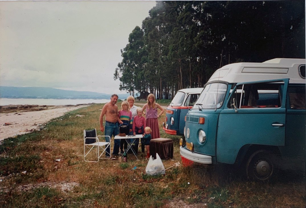My parents with a VW campervan and friends Walter and Tammy in Portugal, parked by the sea with my brother and me