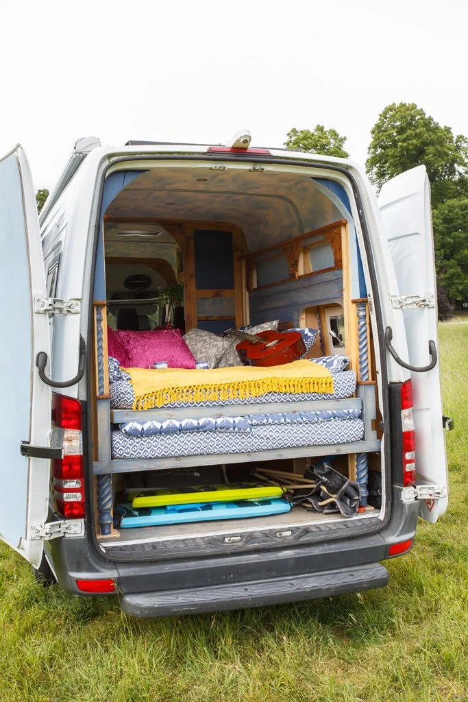Rear sleeping area and practical storage inside Azure, showing the comfortable double bed and easy-access space for boards, luggage and outdoor gear. Ideal for relaxed campervan motorhome hire from Bristol.