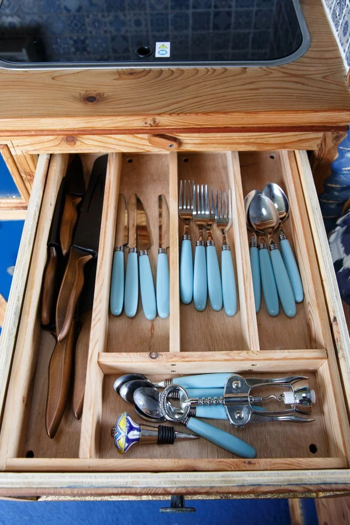 Fully equipped cutlery drawer inside Azure’s handmade campervan kitchen, with thoughtfully organised storage for everyday cooking and dining on the road. Part of Azure’s well-designed interior, ideal for comfortable campervan and motorhome hire from 
