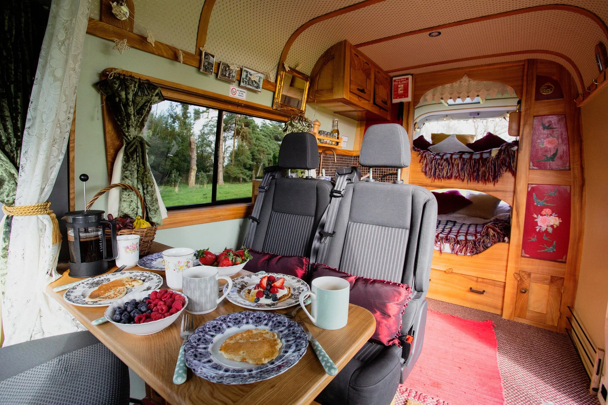 Interior of Roma campervan showing family dining area and fixed bunk beds, a spacious motorhome-style campervan for family hire in the UK
