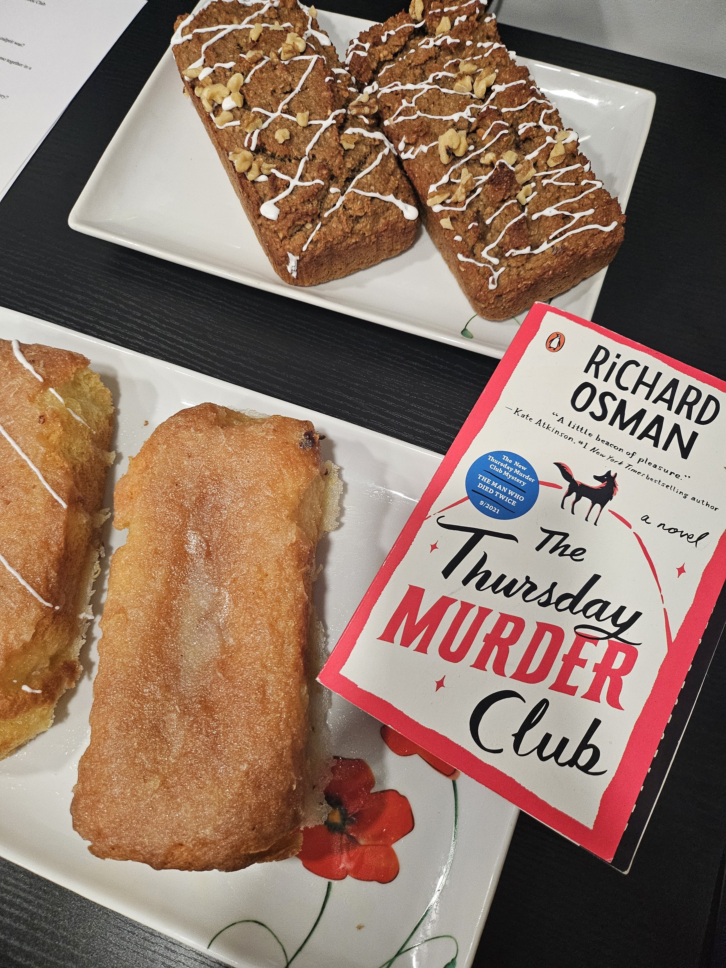 Lemon cake and walnut loaf cake next to the book "The Thursday Murder Club"