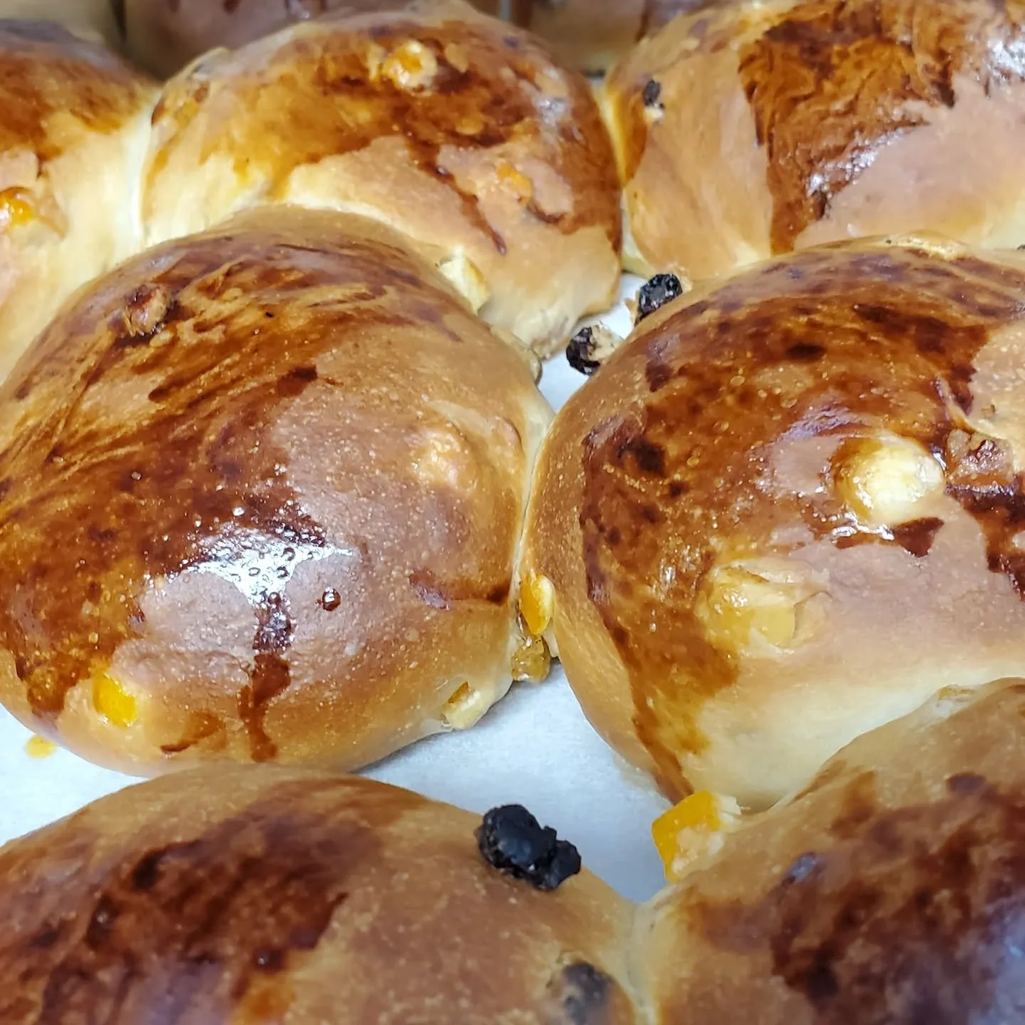 Hot cross buns just out of the oven waiting to be glazed!  Get them today and tomorrow only!  Then they'll be gone until next year!!