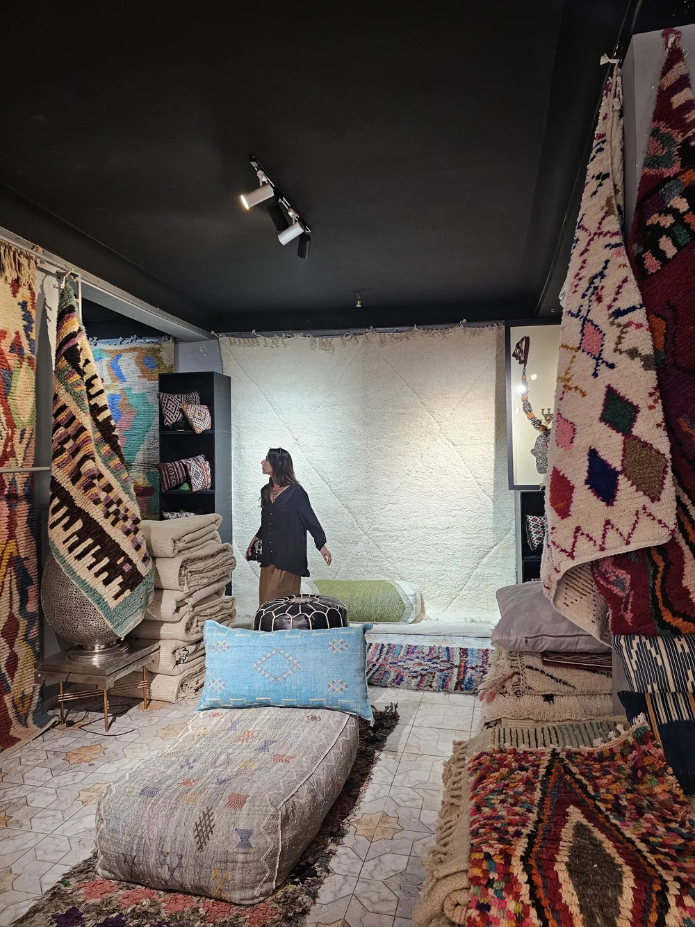 Stephanie Sargon in a rug market in the Marrakech medina
