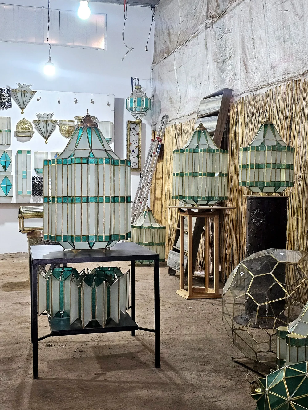 Mohammad's finished stained-glass lamps and handmade pottery