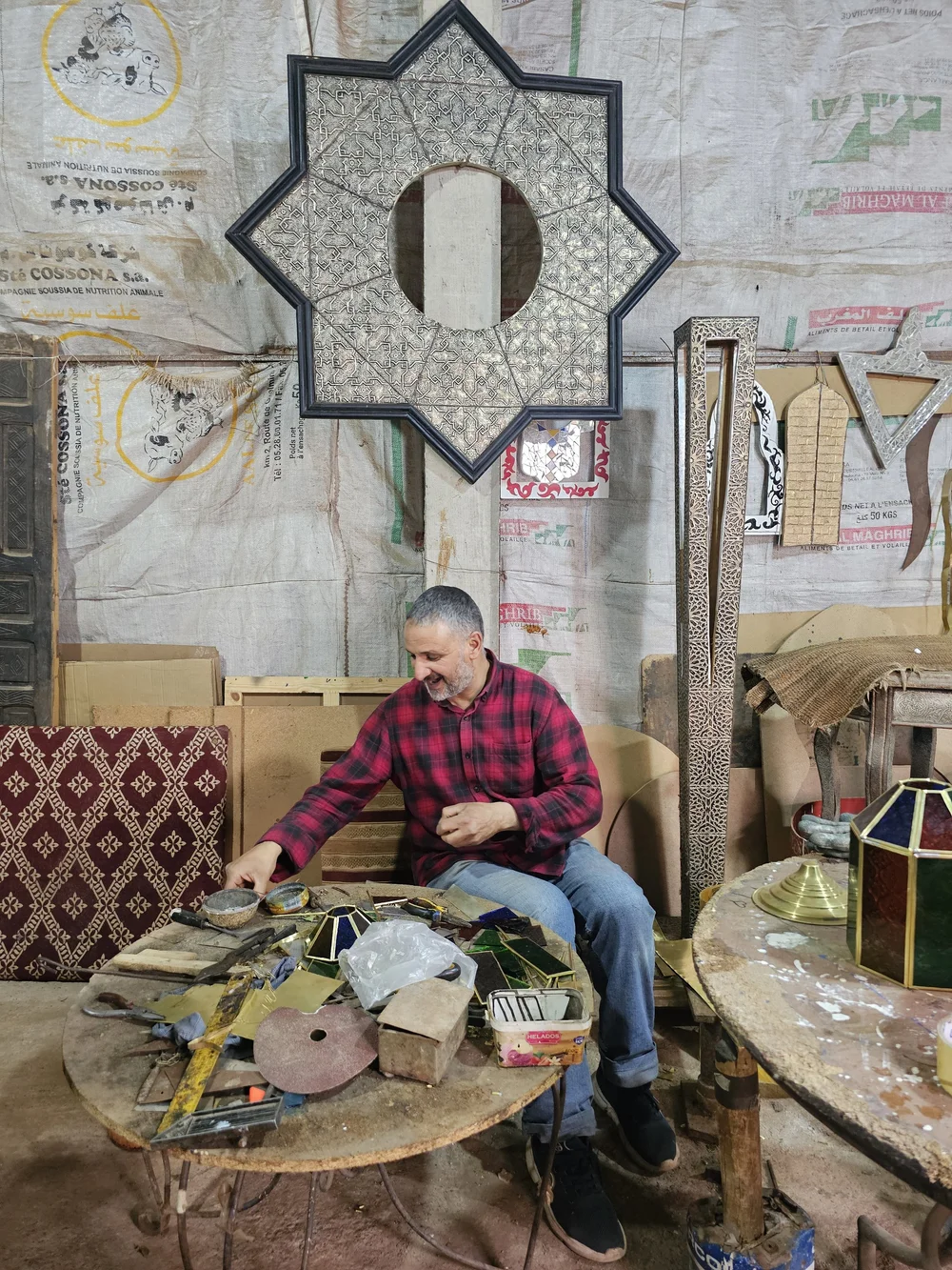 Mohammad, a Moroccan artisan in Ourika, working on his handmade lamps
