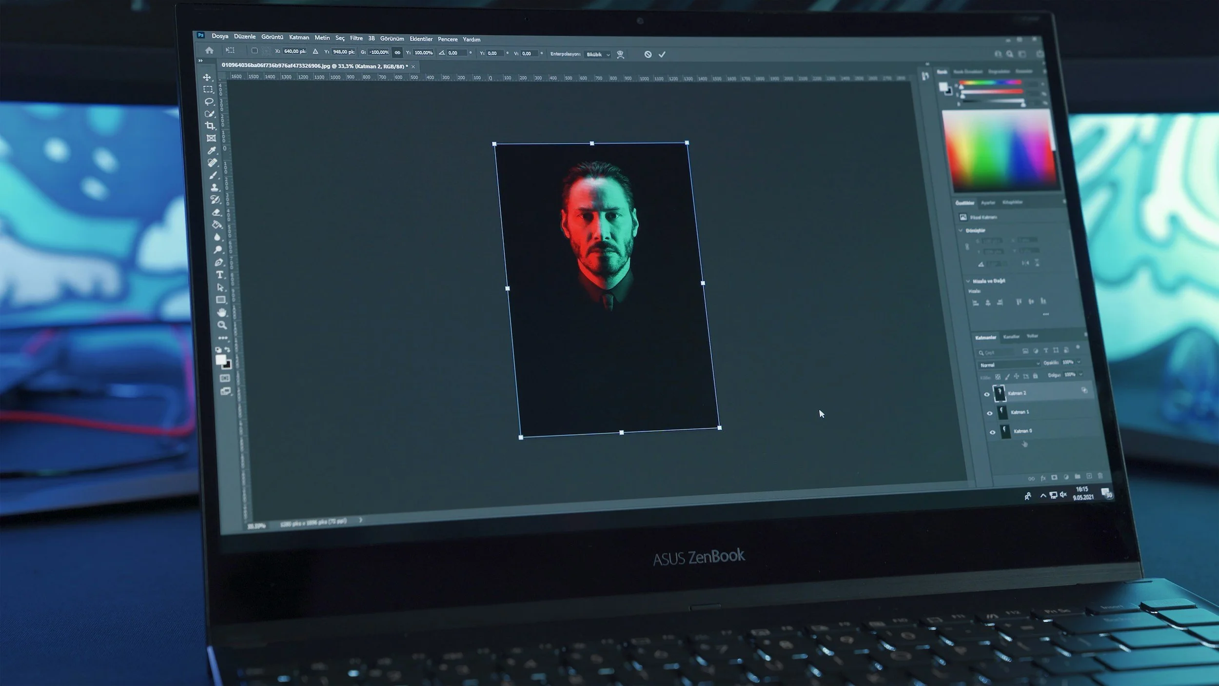 A laptop screen displaying photo editing software with an image of a man with a beard and slicked-back hair, illuminated by red and green lighting.