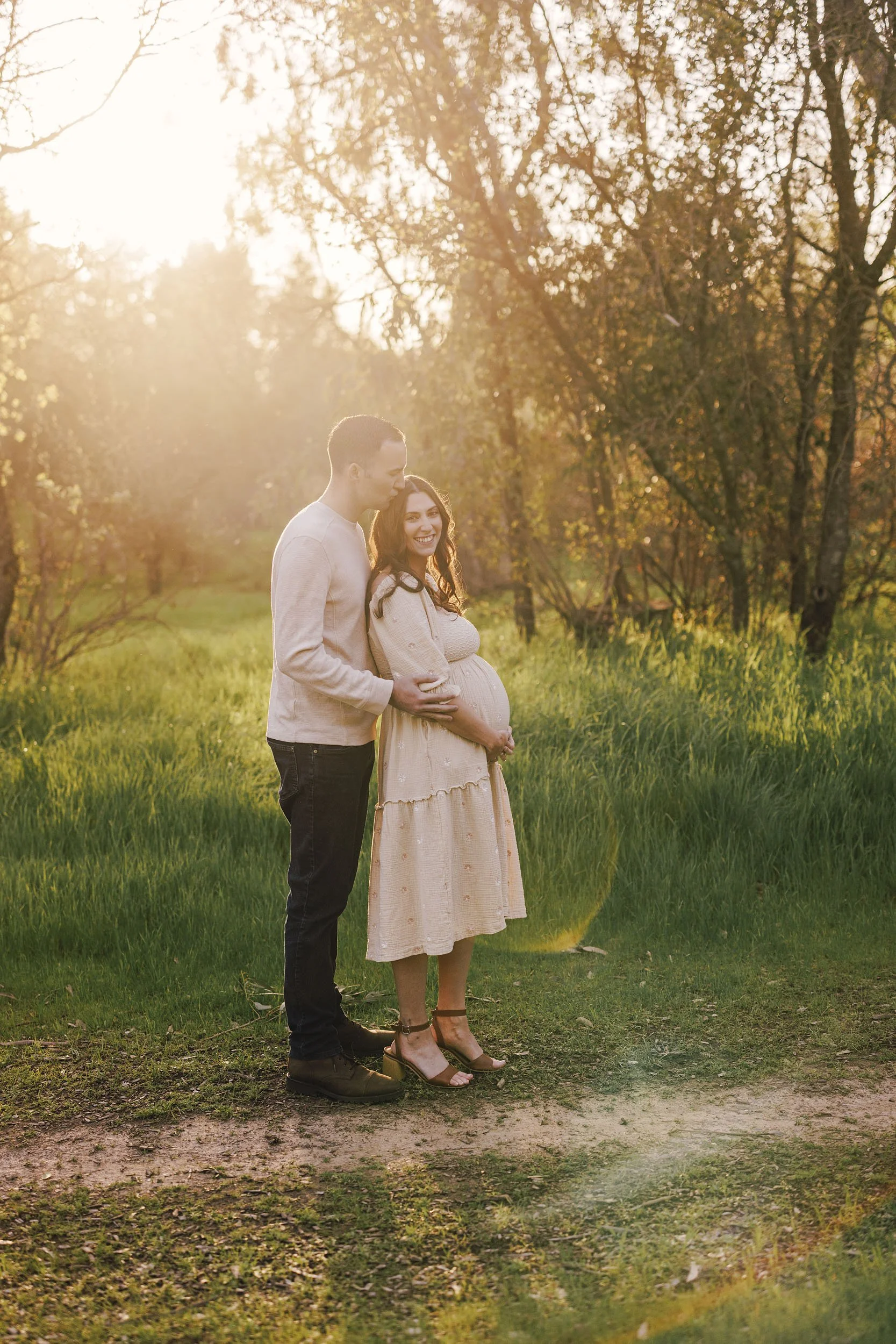 A couple gets their photo taken outside by Sacramento maternity photographer Amy Wright
