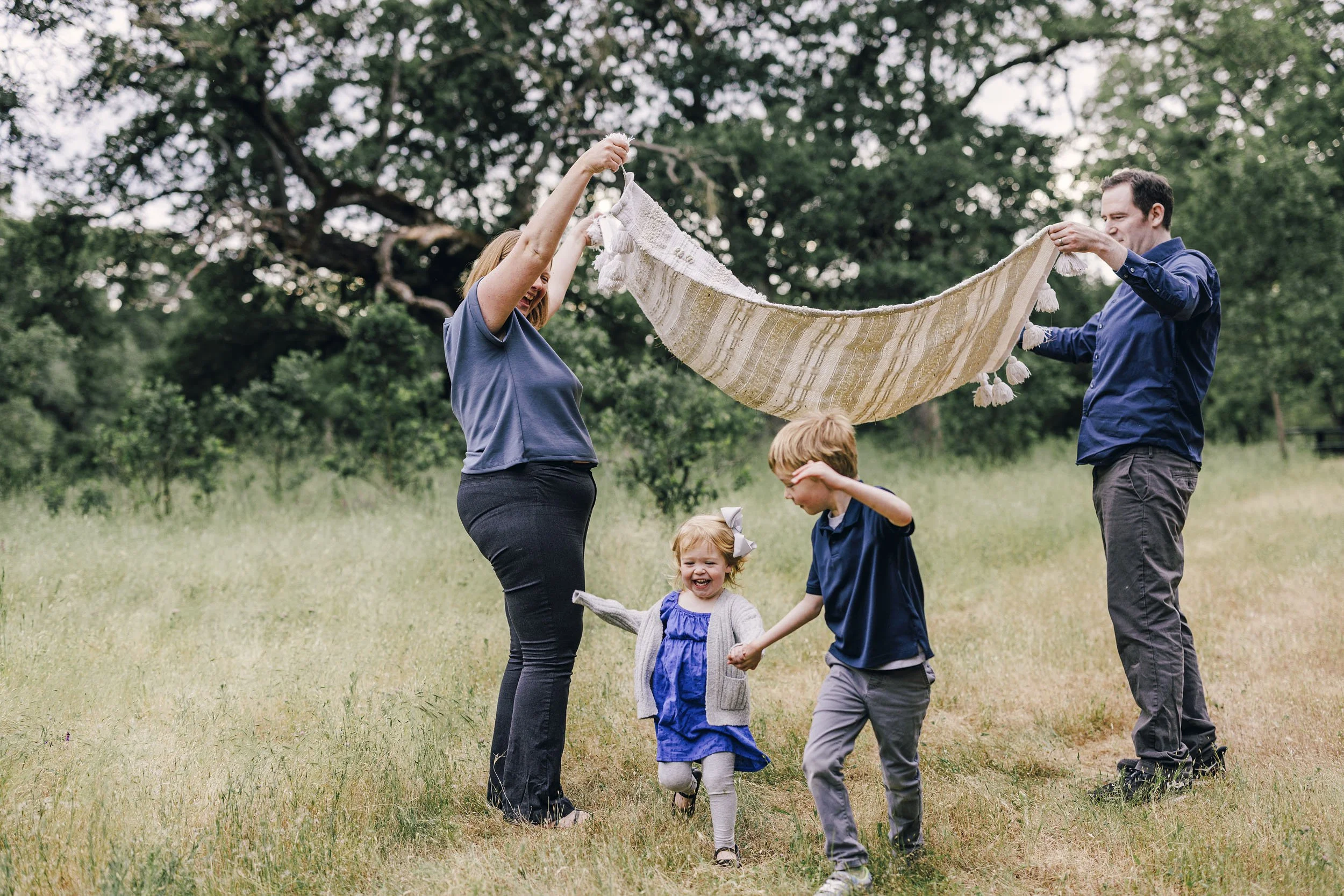 A family plays together during a relaxed family photo session in Roseville, California with lifestyle photographer Amy Wright