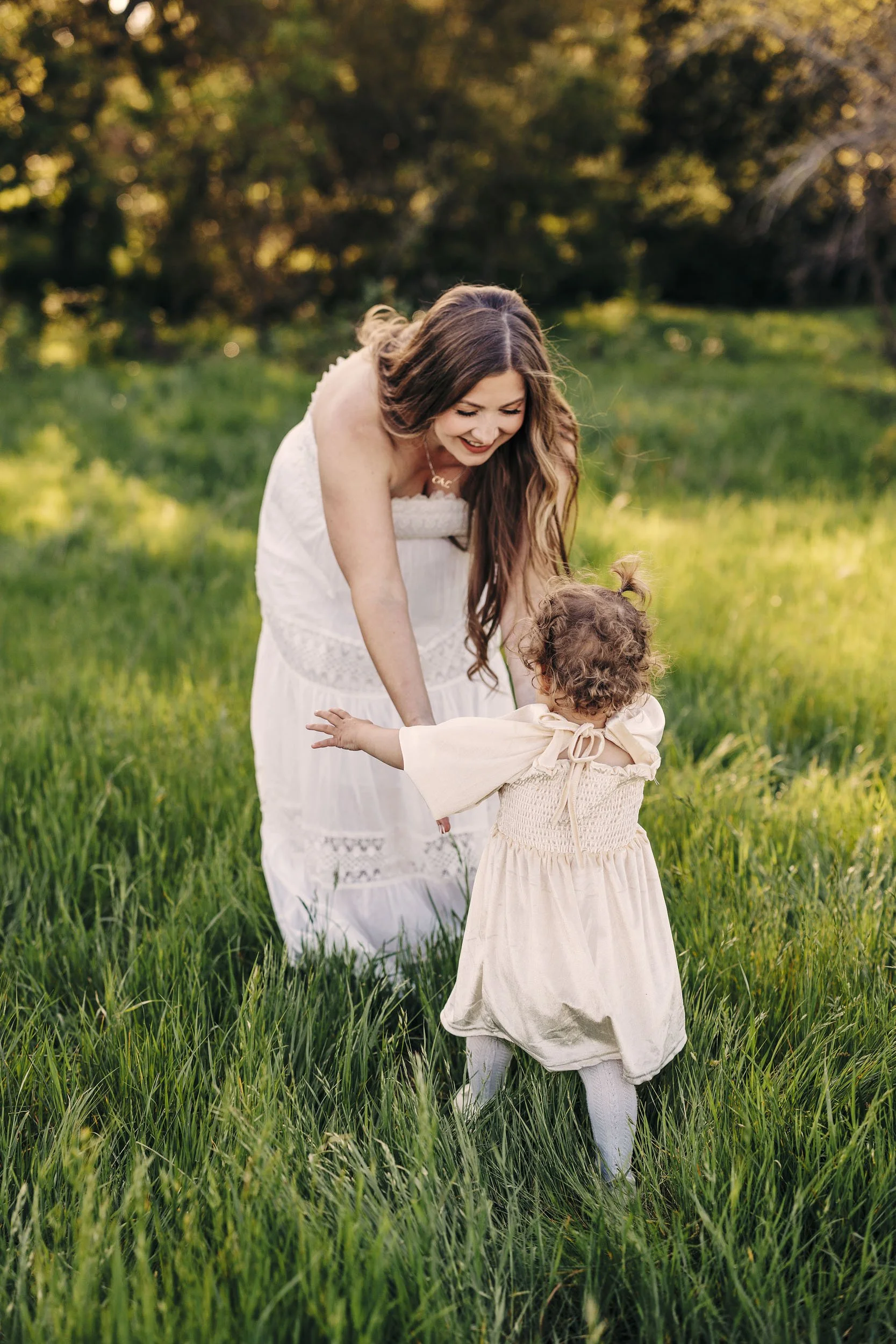 A toddler runs to her mother during a lifestyle photo session in Roseville, California.