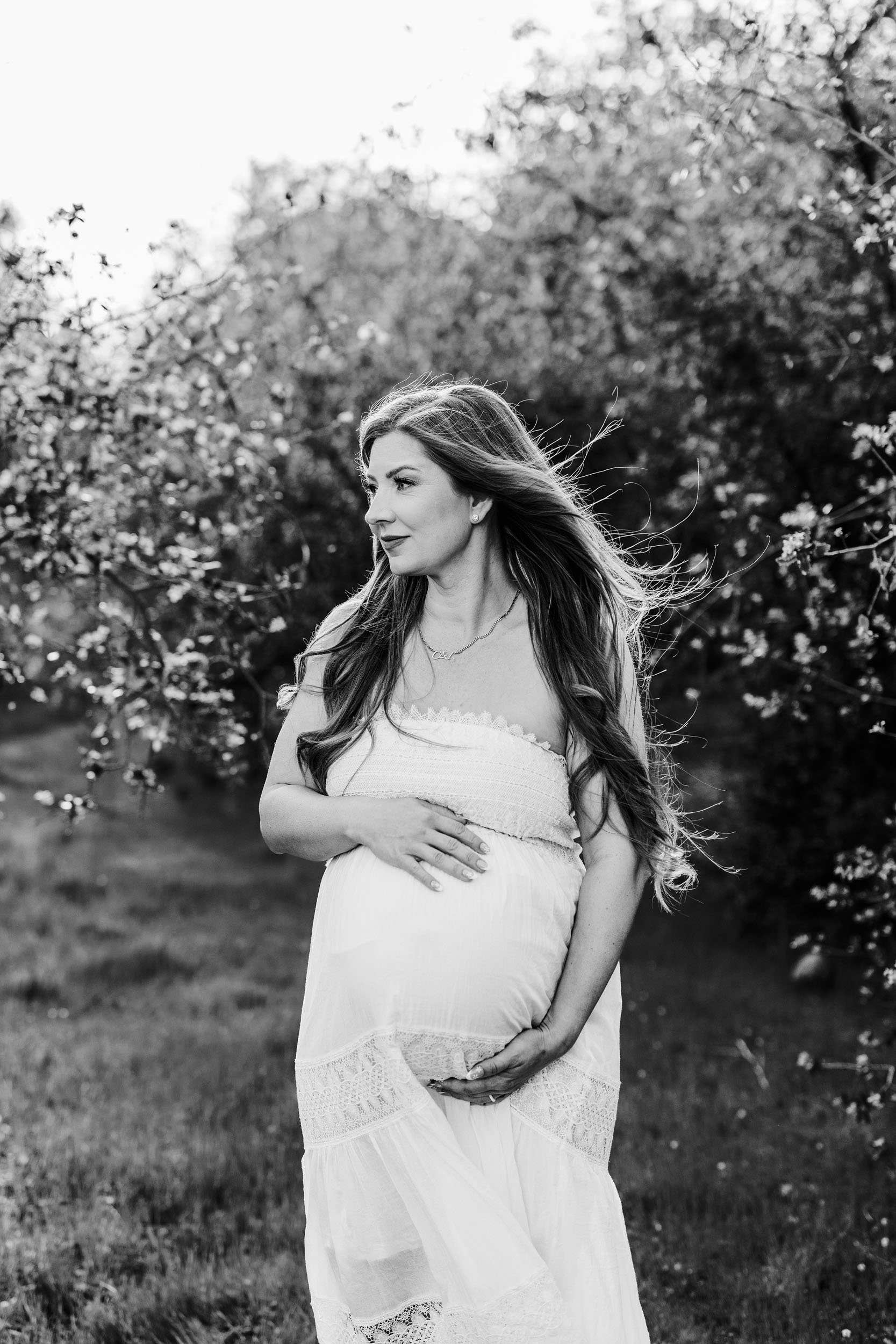 A mother-to-be gets her maternity portraits taken outdoors with Roseville photographer Amy Wright