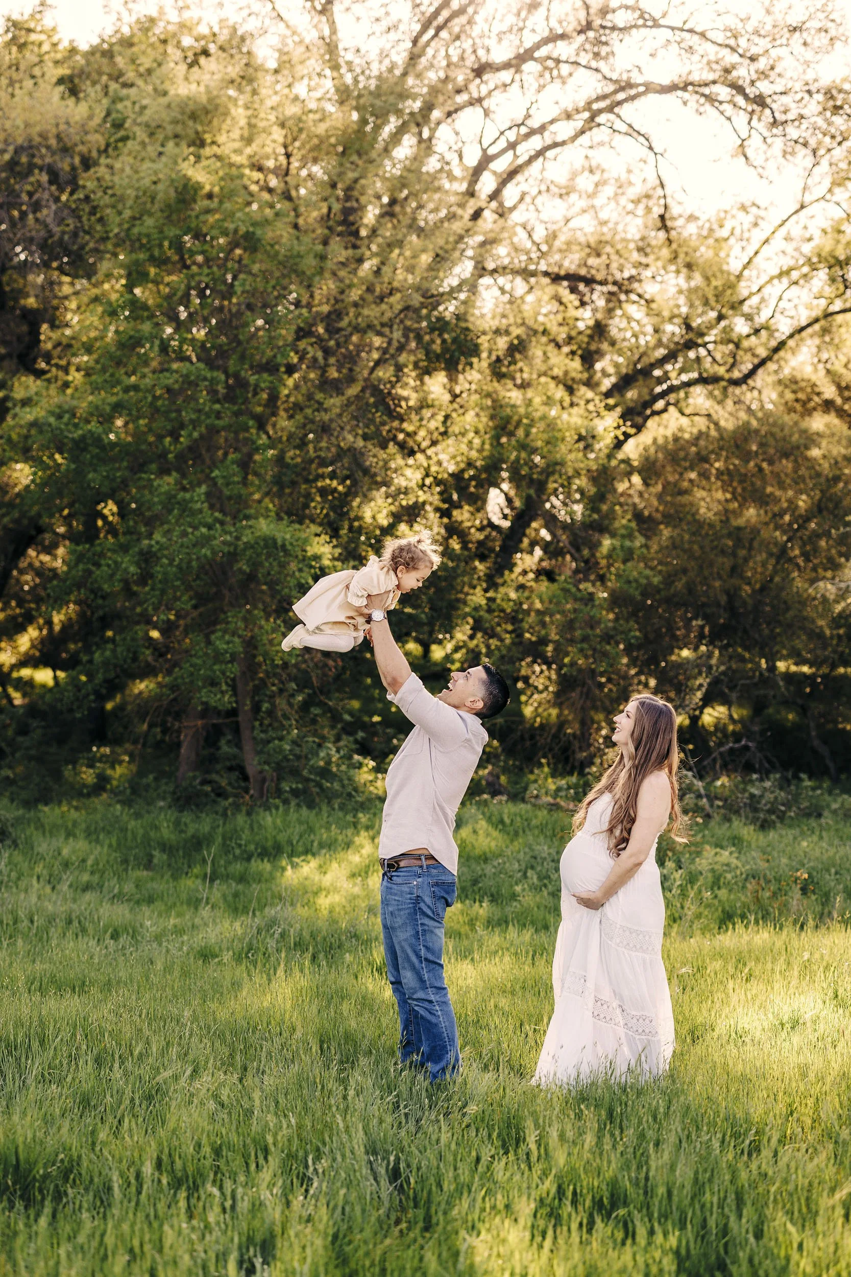 A family of three plays during a maternity session in Roseville with Amy Wright Photography.