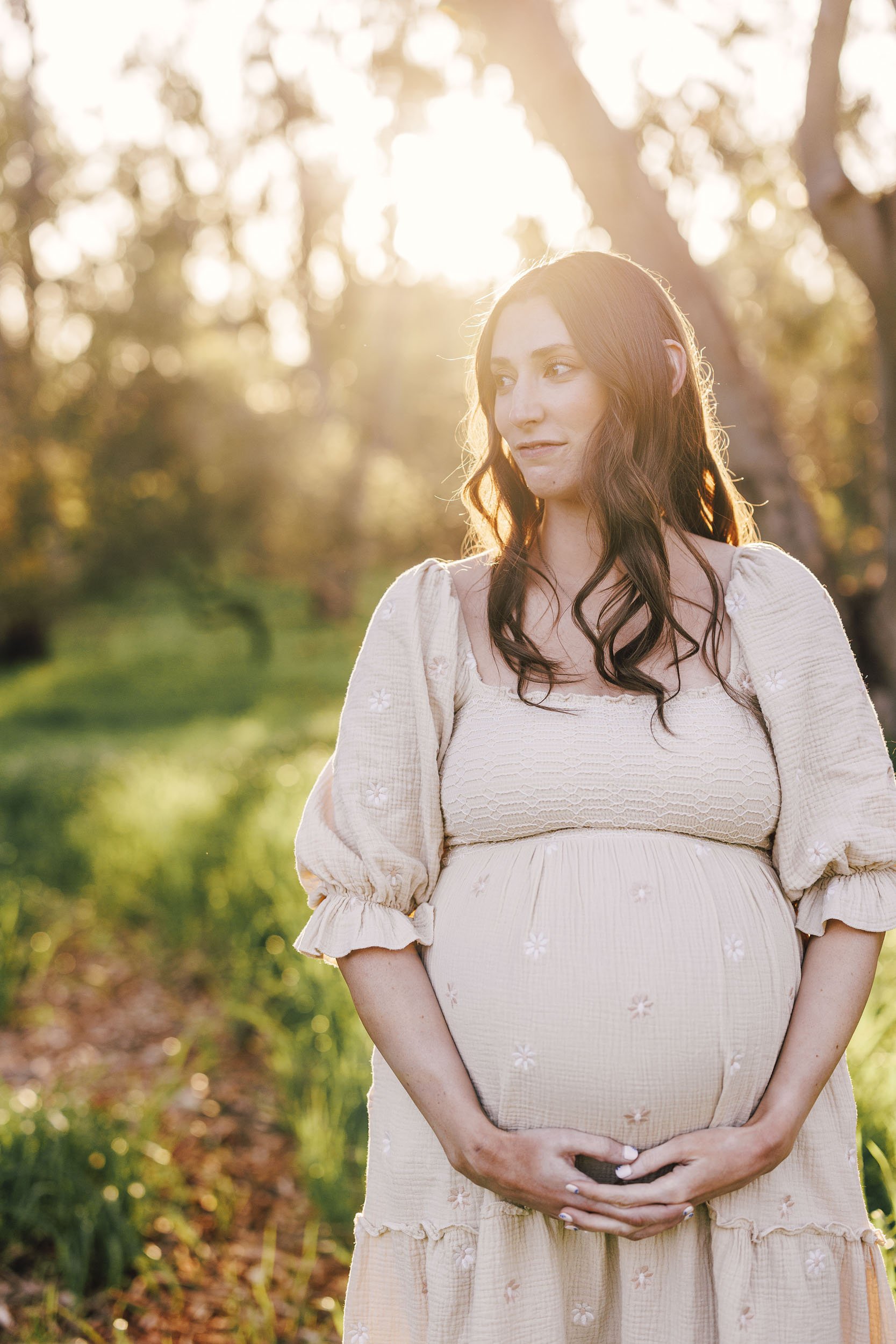 Roseville Maternity photographer takes a photo of a mom-to-be in a light filled, natural setting