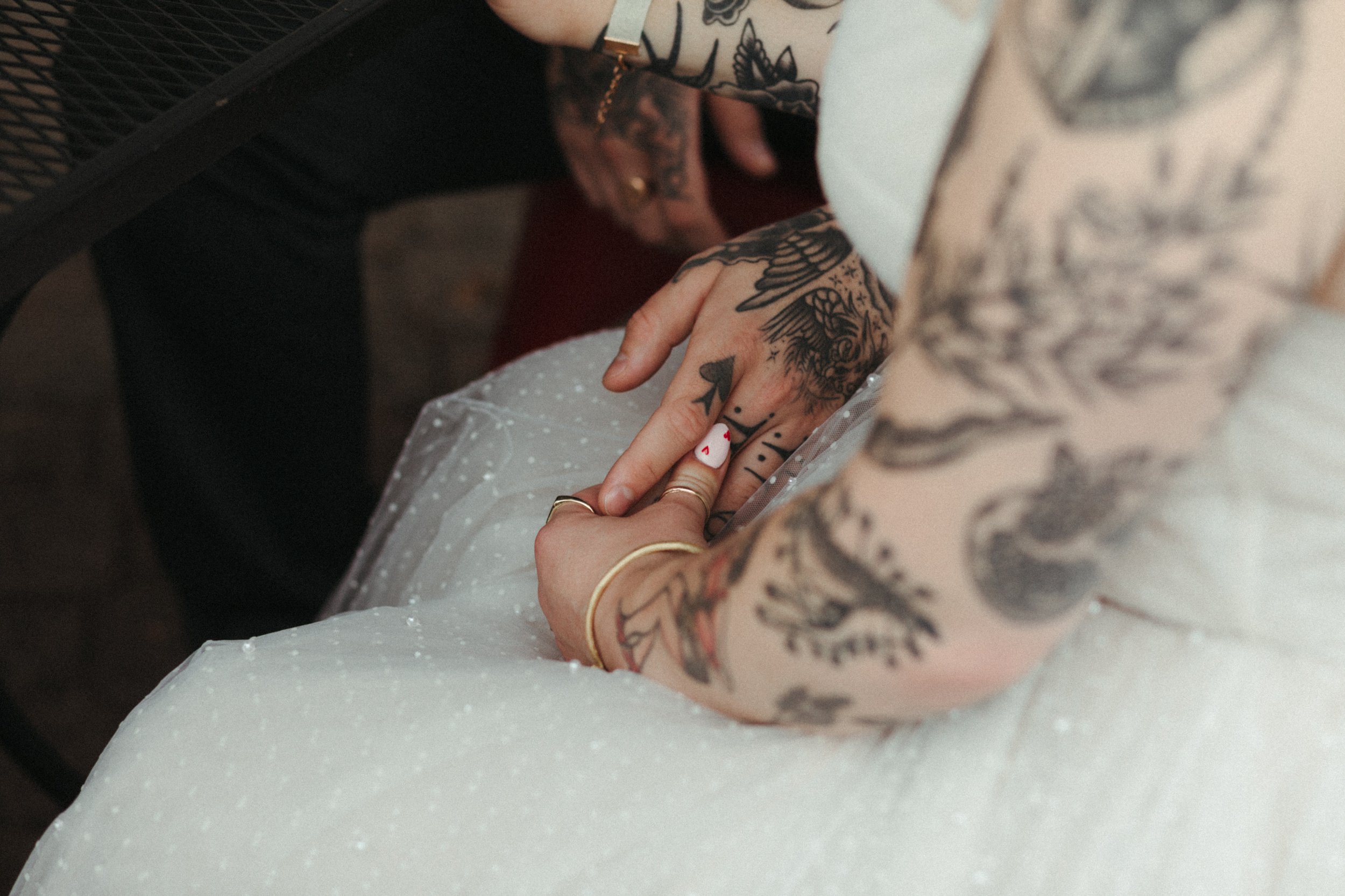 bride and groom hands, wedding rings, wedding jewelry, what to wear, downtown elopement, couples with tattoos, wedding tattoos, anthro