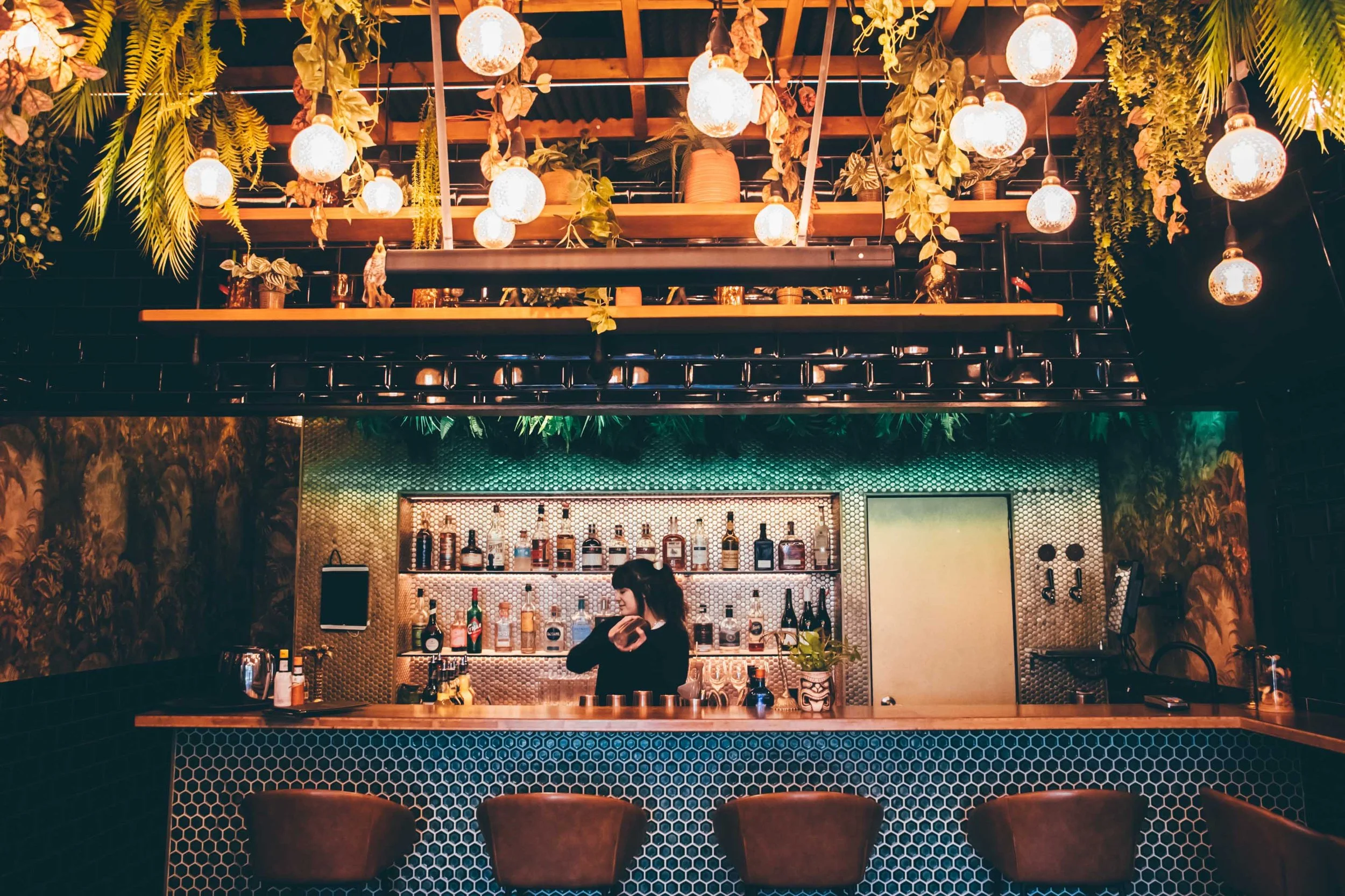 Photo of bartender in Kiki bar shaking a cocktail