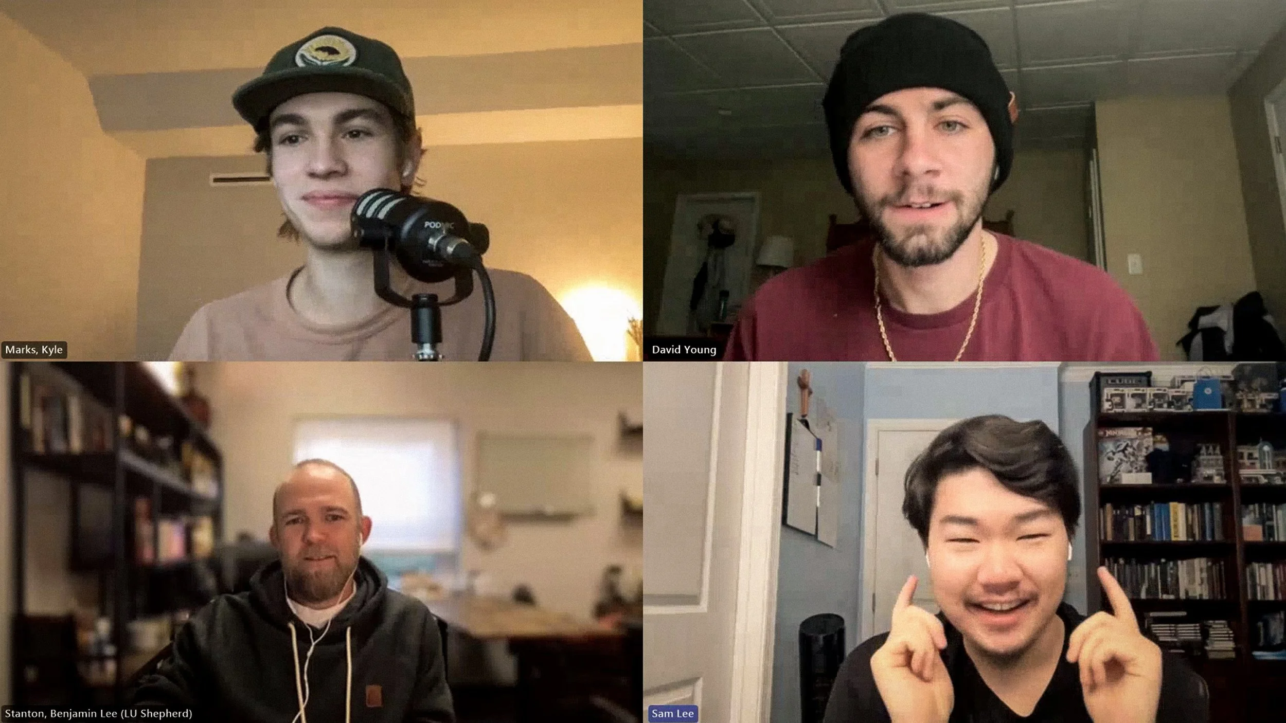 A screenshot of a virtual meeting with five participants, each in their own room. Top left, Kyle Marks with a microphone. Top right, David Young with a beanie. Bottom left, Benjamin Lee in front of a bookshelf. Bottom right, Sam Lee smiling and making finger heart gestures.